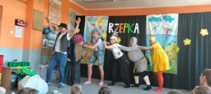 6 rodziców stoi jedno za drugim i próbuje wyrwać rzepkę