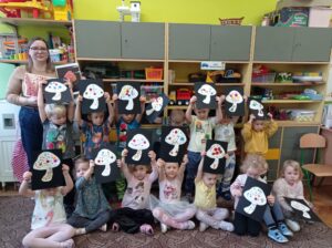 grupa dzieci pokazuje wykonane przez siebie obrazki