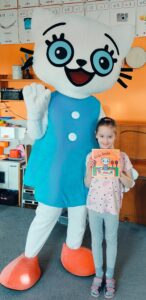 Dziewczynka pozuje z Kicią Kocią